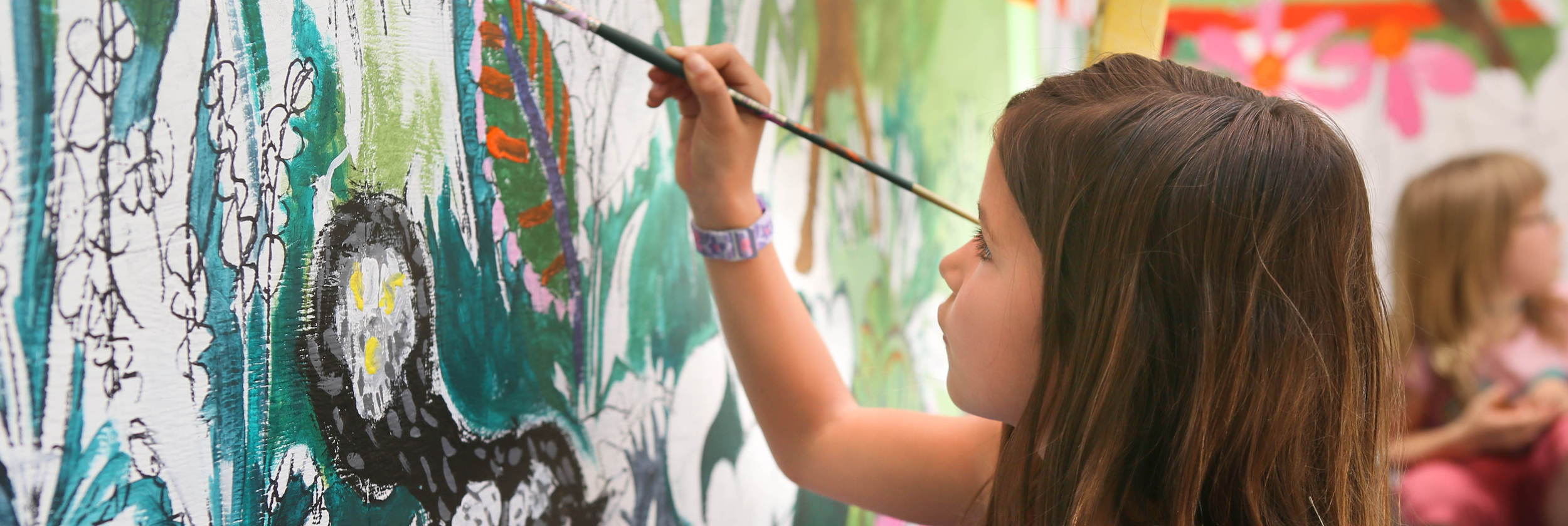 Elementary student painting mural